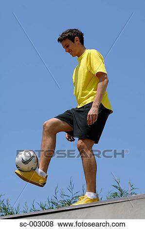 Teenage boy juggling soccer ball View Large Photo Image Stock Photo - Teenage boy juggling soccer ball. Fotosearch