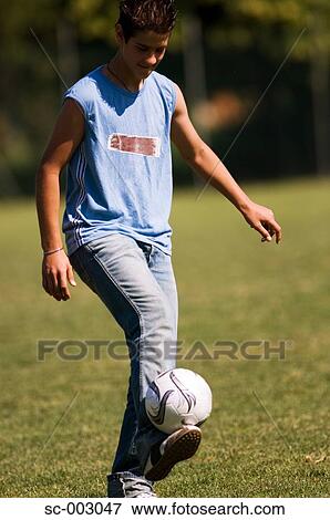Stock Photo - Teenage boy juggling soccer ball. Fotosearch