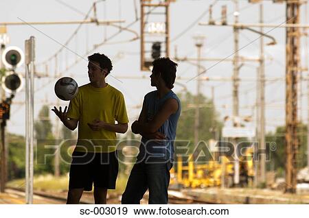 Stock Photo - Teenage boys on station platform. Fotosearch