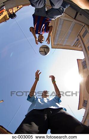 Stock Photography - Teenage boys playing with ball. Fotosearch