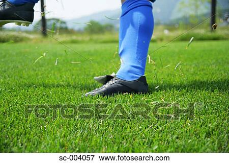 Stock Photo - Close-up of player after kicking ball. Fotosearch