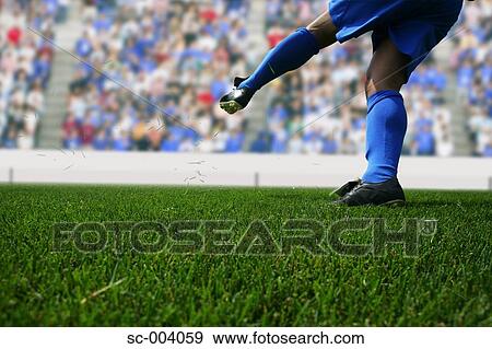 Stock Photo - Close-up of player after kicking ball. Fotosearch