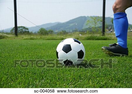 Close-up of player kicking ball View Large Photo Image Stock Photo - Close-up of player kicking ball. Fotosearch