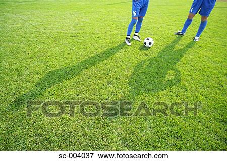 Stock Photo - Shadows of two soccer players with ball. Fotosearch