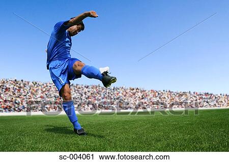 Stock Image - Soccer player after kicking ball. Fotosearch