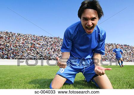 Stock Image - Soccer player celebrating. Fotosearch