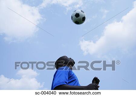 Stock Image - Soccer player heading ball. Fotosearch