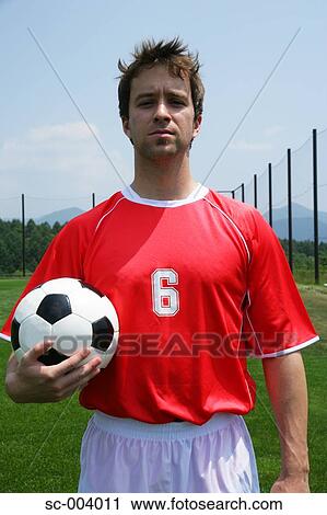 Soccer player holding ball View Large Photo Image Stock Image - Soccer player holding ball. Fotosearch