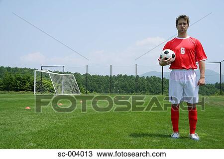 Soccer player holding ball View Large Photo Image Stock Image - Soccer player holding ball. Fotosearch