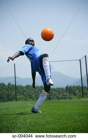 Soccer player juggling ball View Large Photo Image Picture - Soccer player juggling ball. Fotosearch