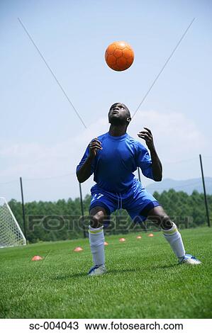 Stock Image - Soccer player juggling ball. Fotosearch