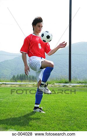 Stock Photo - Soccer player juggling ball. Fotosearch