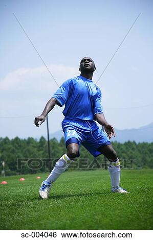 Stock Photograph - Soccer player juggling ball. Fotosearch