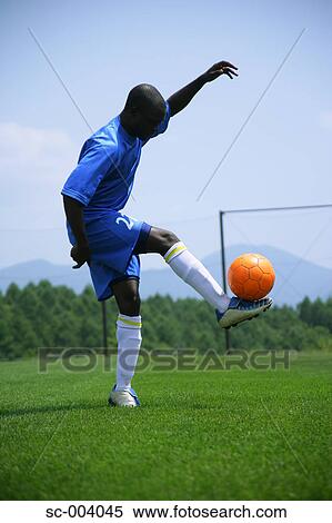 Stock Photography - Soccer player juggling ball. Fotosearch