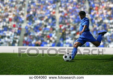 Soccer player kicking ball View Large Photo Image Stock Image - Soccer player kicking ball. Fotosearch