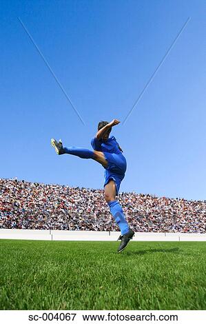 Stock Photo - Soccer player kicking ball. Fotosearch