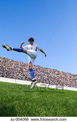 Soccer player kicking ball View Large Photo Image Stock Photo - Soccer player kicking ball. Fotosearch