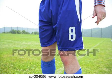 Soccer player on sideline View Large Photo Image Stock Photograph - Soccer player on sideline. Fotosearch