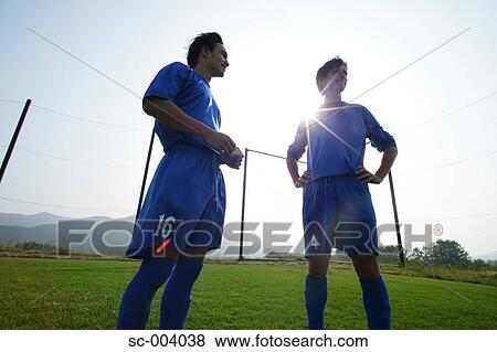 Stock Photo - Two soccer players chatting on sideline. Fotosearch