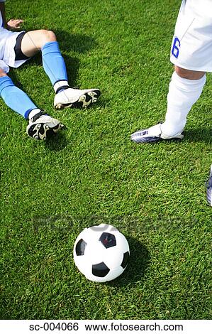 Stock Photograph - Two soccer players with ball. Fotosearch