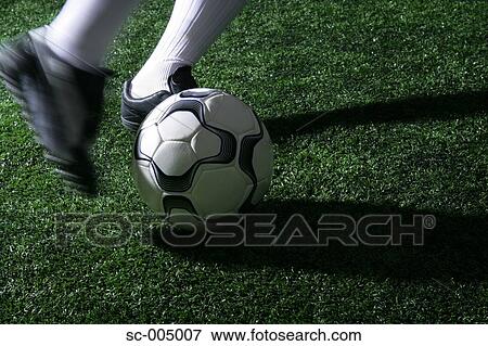 Close-up of foot kicking soccer ball View Large Photo Image Stock Photo - Close-up of foot kicking soccer ball. Fotosearch