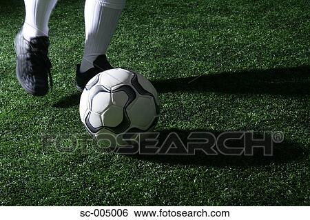 Close-up of foot kicking soccer ball View Large Photo Image Stock Photograph - Close-up of foot kicking soccer ball. Fotosearch