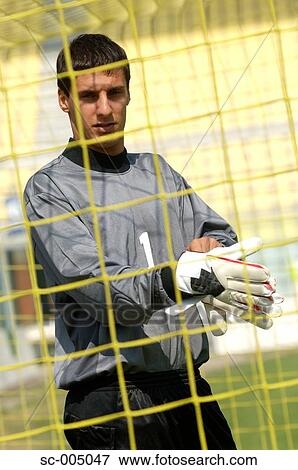 Goalkeeper putting on gloves View Large Photo Image Stock Photo - Goalkeeper putting on gloves. Fotosearch
