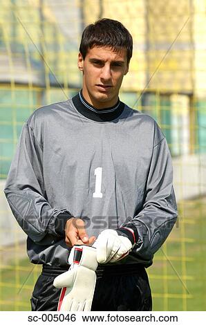 Stock Photograph - Goalkeeper putting on gloves. Fotosearch