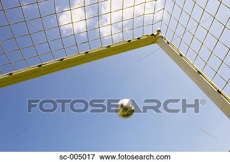 Stock Photo - Soccer ball flying into top corner of goal. Fotosearch