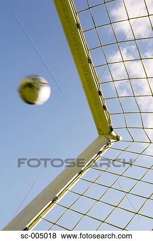 Stock Photo - Soccer ball flying into top corner of goal. Fotosearch