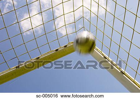 Soccer ball flying into top corner of goal View Large Photo Image Stock Photograph - Soccer ball flying into top corner of goal. Fotosearch