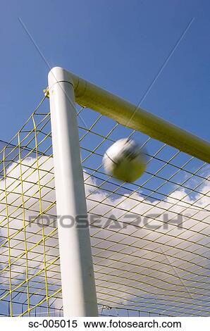 Soccer ball flying into top corner of goal View Large Photo Image Stock Photography - Soccer ball flying into top corner of goal. Fotosearch
