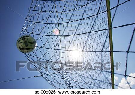 Stock Photograph - Soccer ball hitting back of net. Fotosearch