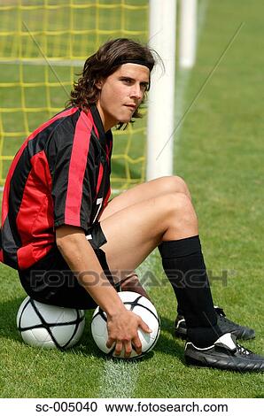 Soccer player sitting on soccer ball View Large Photo Image Stock Image - Soccer player sitting on soccer ball. Fotosearch