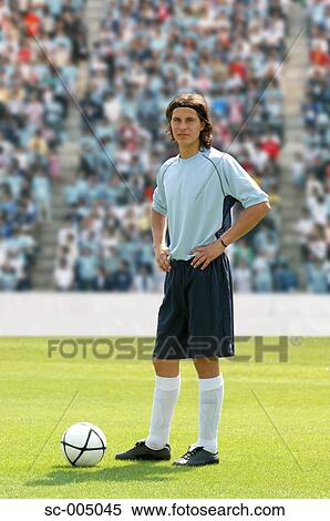 Soccer player standing on pitch View Large Photo Image Stock Photography - Soccer player standing on pitch. Fotosearch