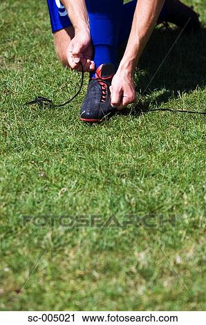 Soccer player tying boot laces View Large Photo Image Stock Image - Soccer player tying boot laces. Fotosearch