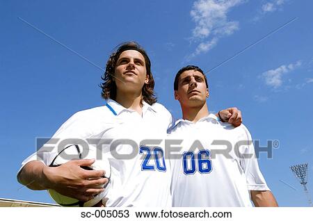 Stock Image - Two soccer friends wearing 2006 on their shirts. Fotosearch
