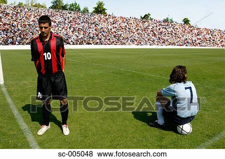 Two soccer players waiting on pitch View Large Photo Image Stock Photo - Two soccer players waiting on pitch. Fotosearch