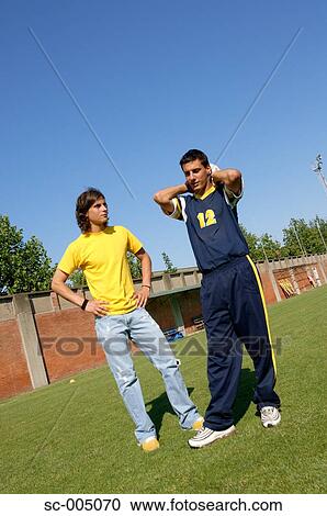 Young friends chatting on soccer field View Large Photo Image Stock Image - Young friends chatting on soccer field. Fotosearch