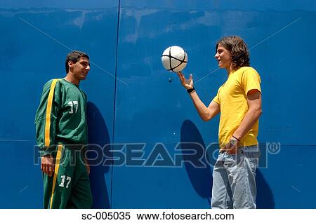 Young friends with soccer ball in front of blue gate View Large Photo Image Stock Photography - Young friends with soccer ball in front of blue gate. Fotosearch