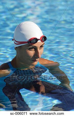 Stock Image - Female Swimmer Floating in Pool. Fotosearch