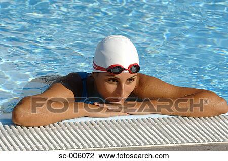 Stock Image - Female Swimmer Leaning on Poolside. Fotosearch