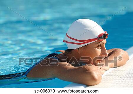 Stock Image - Female Swimmer Leaning on Poolside. Fotosearch