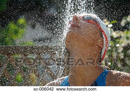 Stock Image - Female Swimmer Taking a Shower. Fotosearch