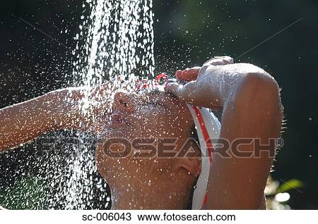 Stock Image - Female Swimmer Taking a Shower. Fotosearch