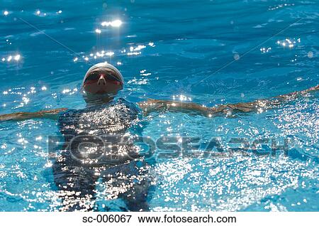 Stock Photo - Front View of Female Swimmer Swimming Backstroke. Fotosearch