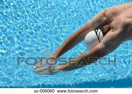 Stock Image - Male Swimmer Diving, Hands Just Entering Water. Fotosearch