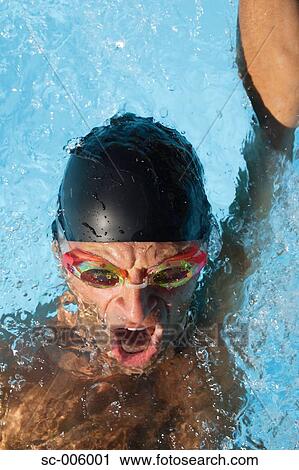 Stock Image - Male Swimmer Swimming Backstroke. Fotosearch