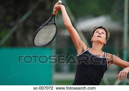 Stock Image - Female Tennis Player Swinging Racquet, Racket. Fotosearch
