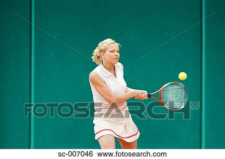 Front View of Female Tennis Player Hitting Ball View Large Photo Image Stock Photograph - Front View of Female Tennis Player Hitting Ball. Fotosearch